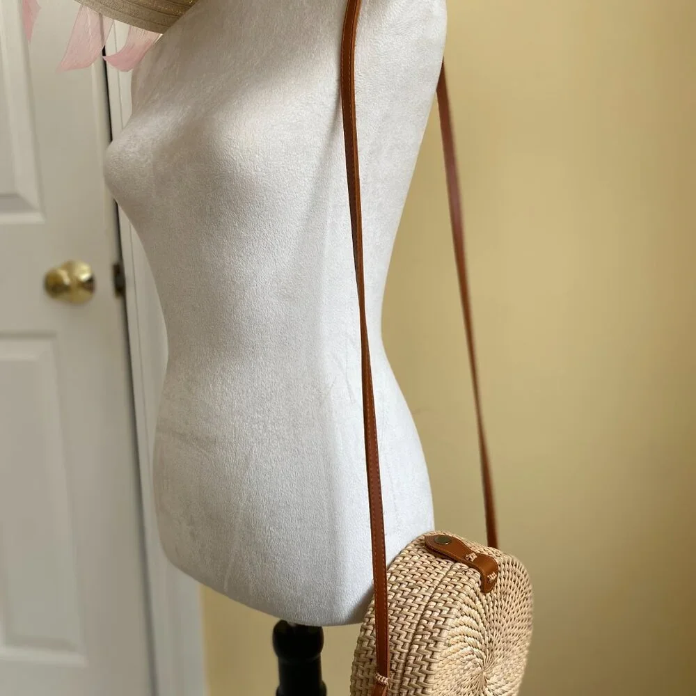 Round solid rattan woven crossbody purse cloth lined, leather accents.